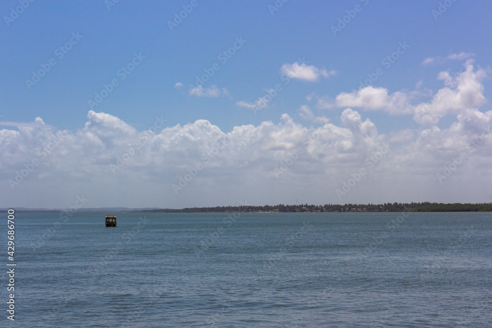 Blue sea and blue sky with clouds in the dry mangrove(Mangue Seco) in Bahia.