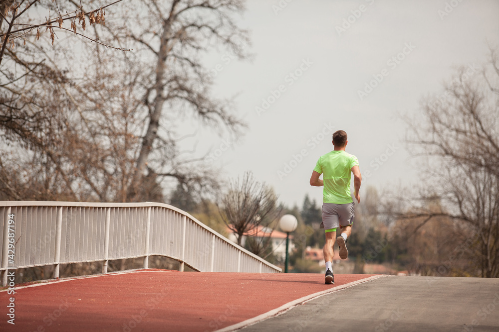 Crossing the bridge with his running routine Crossing the bridge with his running routine