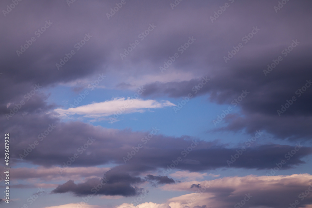 Fototapeta premium Blue sky behind dark storm clouds background texture, thunderstorm