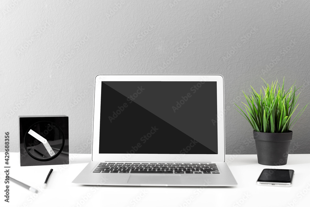 Modern laptop on white table. Comfortable workplace Modern laptop on white table. Comfortable workplace