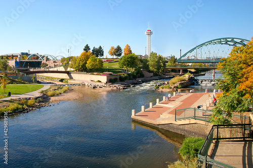 Confluence Park Denver Colorado with Cherry Creek and the South Platte River flowing beneath the Speer Avenue bridge. Pepsi Center and Elitches gardens backdrop