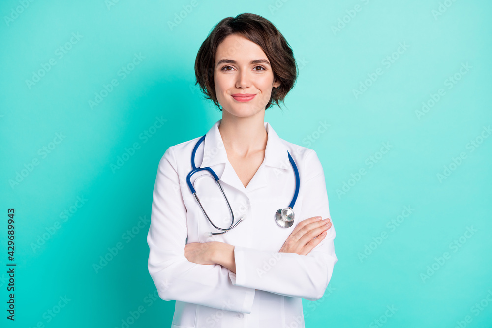 Photo of young woman happy positive smile folded hands intern medic isolated over teal color background Photo of young woman happy positive smile folded hands intern medic isolated over teal color background