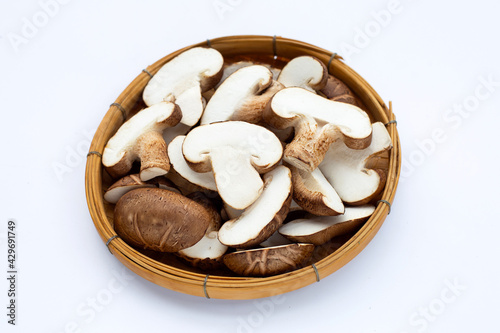 Fresh shiitake mushrooms in basket on white