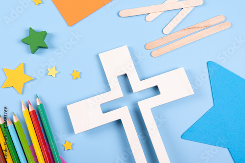  Vacation Bible School craft supply with wooden cross. Christian concept. 
Copy space text. Selective focus.