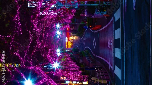 A night timelapse of the illuminated street in Shibuya vertical shot panning photo