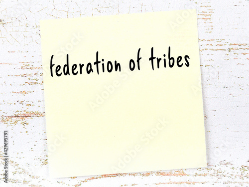 Yellow sheet of paper with word federation of tribes. Reminder concept