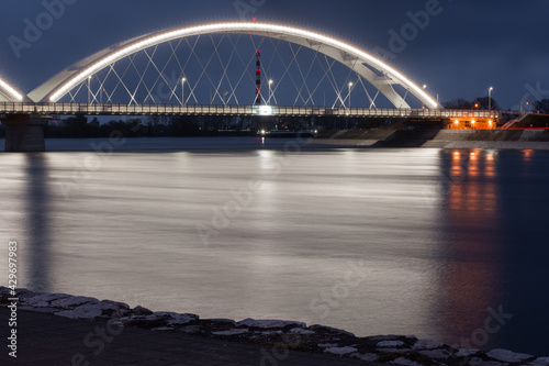 Long exposure of a bridge over the river Danube. Lights glowing and reflecting in the river. 
