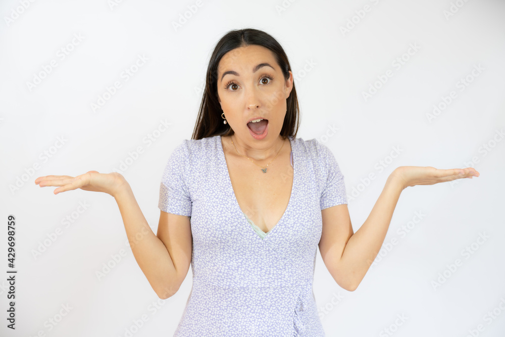 Young hispanic woman wearing casual clothes clueless and confused with open arms, no idea and doubtful face.