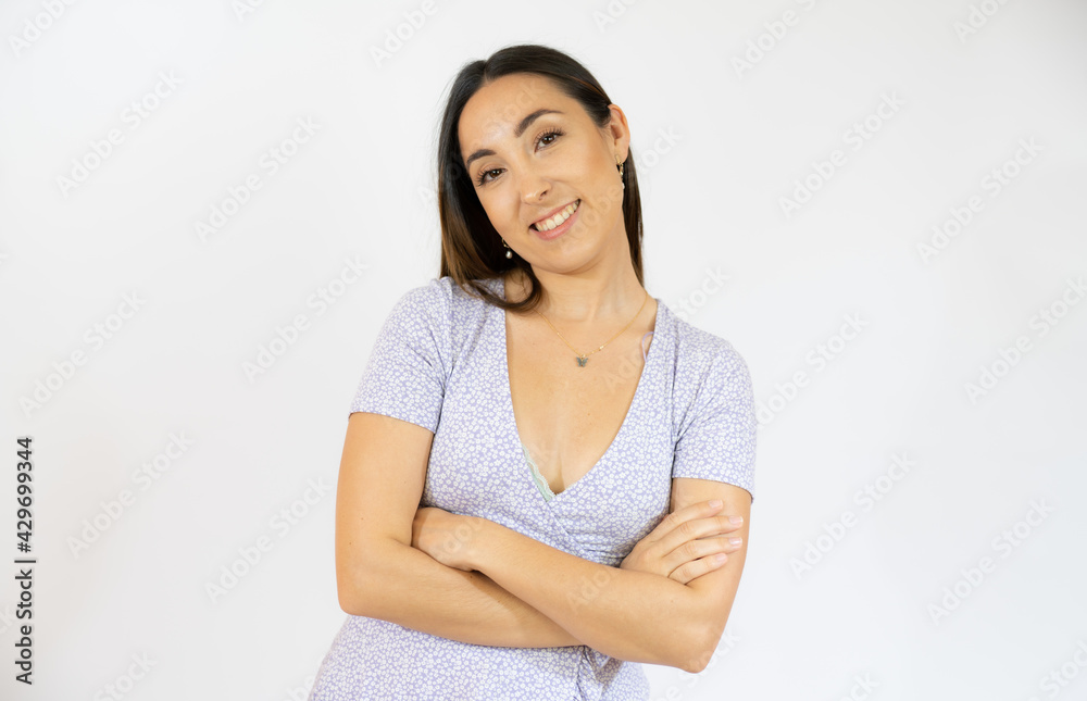 Young smiling woman with arms folded over white background Young smiling woman with arms folded over white background