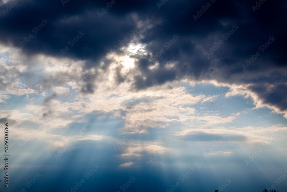 Stormy  sky with sun rays shining through clouds