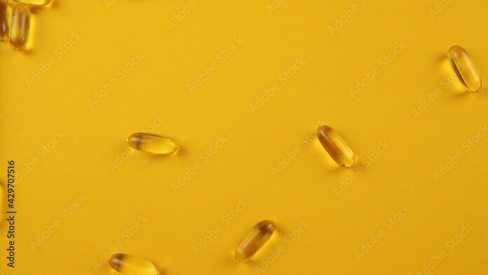 Omega 3 capsules on an orange background. Food supplements, vitamins. Omega 3 capsules on an orange background. Food supplements, vitamins.