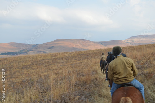 Group of Indian Horse riding riders on a trail in Drakensberg region in South Africa