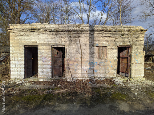 Fototapeta Naklejka Na Ścianę i Meble -  old and abandoned brick barn outside view at daytime