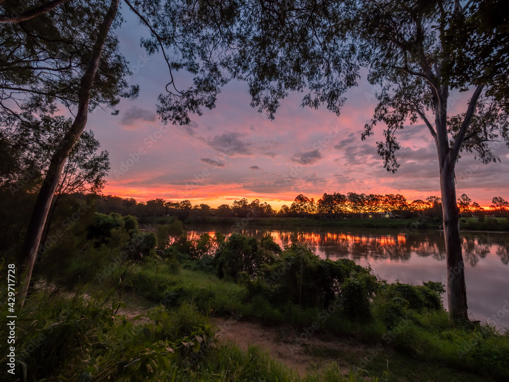Naklejka premium Colourful Riverside Sunset with Reflections