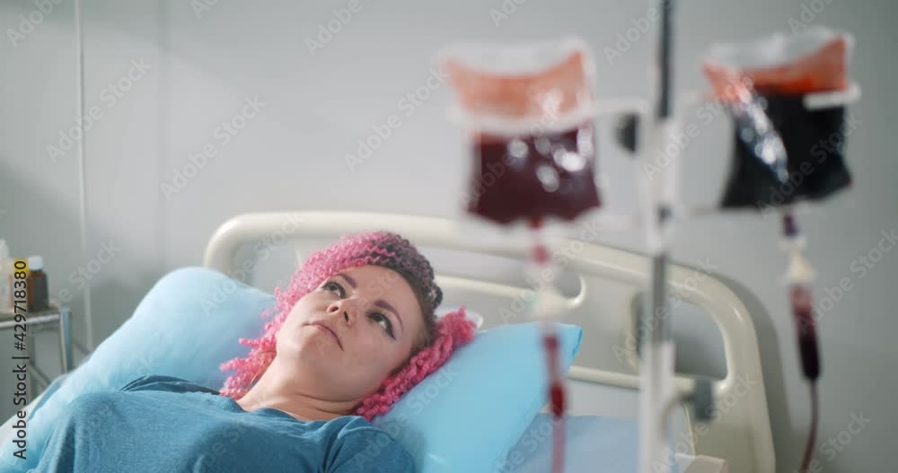 Blood transfusion to young woman patient in hospital bed Blood transfusion to young woman patient in hospital bed