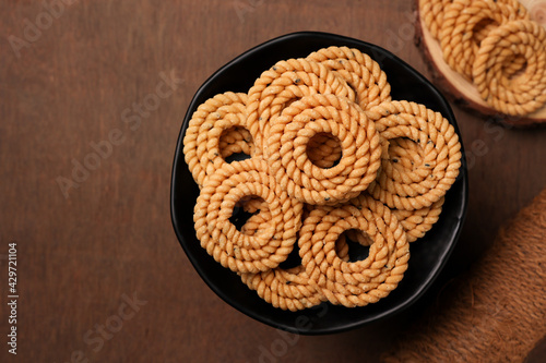 Rice murukku , savoury , chakli, chakali Indian milk tea chai Kerala snack deep fried coconut oil traditional South Indian Tamil Nadu India, Sri Lanka,   Onam, Vishu, Diwali Deepawali, Ramadan, Eid photo