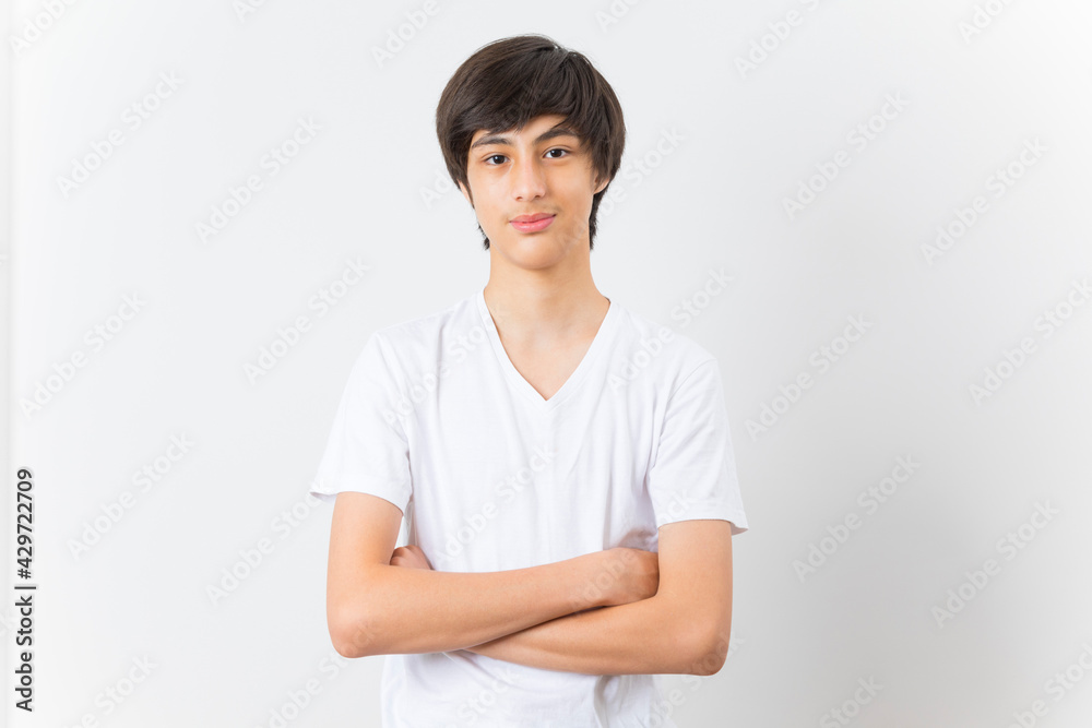Teenager boy wearing t-shirt over white isolated background happy face smiling with crossed arms looking at the camera. Teenager boy wearing t-shirt over white isolated background happy face smiling with crossed arms looking at the camera.