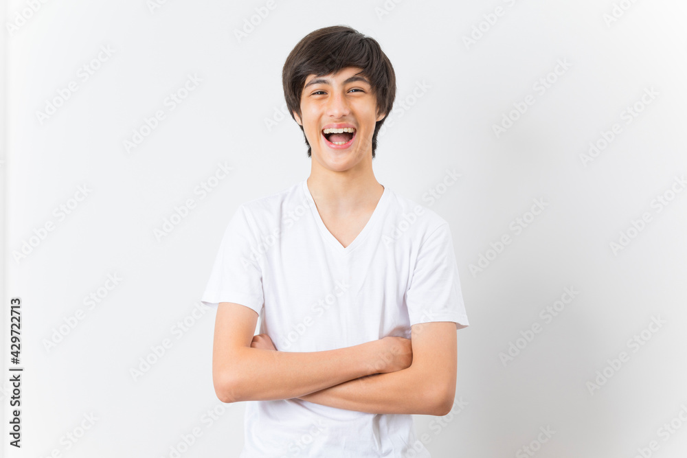 Teenager boy wearing t-shirt over white isolated background happy face smiling with crossed arms looking at the camera. Teenager boy wearing t-shirt over white isolated background happy face smiling with crossed arms looking at the camera.