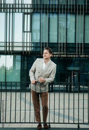 Portrait of an handsome businessman, summer day, outdoors near modern business centre