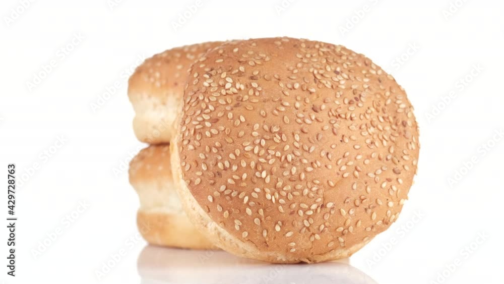 sesame buns. sesame hamburger buns isolated on white background, rotation. 4K UHD video sesame buns. sesame hamburger buns isolated on white background, rotation. 4K UHD video