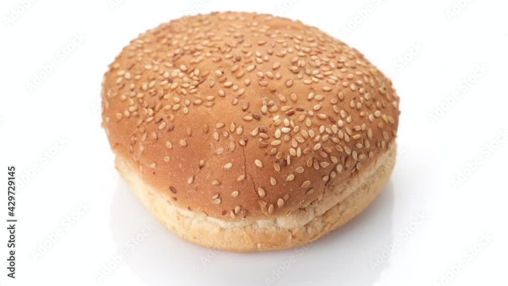 sesame hamburger bun isolated on white background, rotation. 4K UHD video sesame hamburger bun isolated on white background, rotation. 4K UHD video