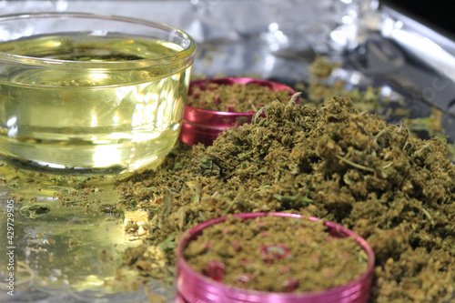Closeup of vegetable oil to be infused with decarboxylated cannabis flowers and leaves photo