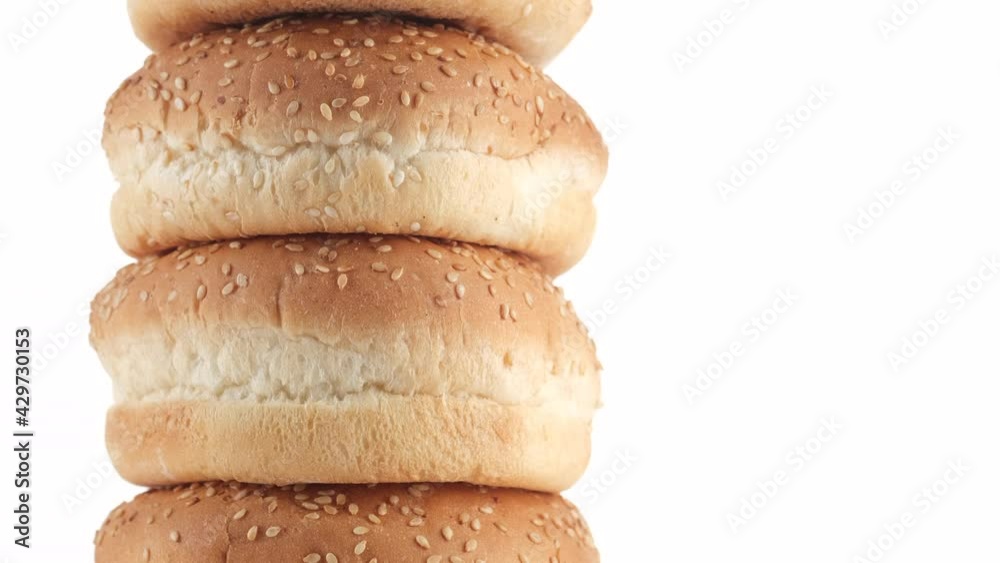 sesame hamburger buns isolated on white background. the frame moves from bottom to top. 4K UHD video sesame hamburger buns isolated on white background. the frame moves from bottom to top. 4K UHD video