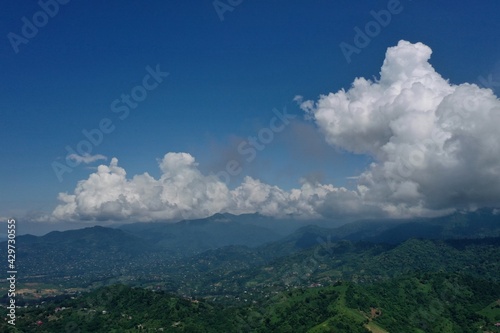 view of mountains, forest and village from drone