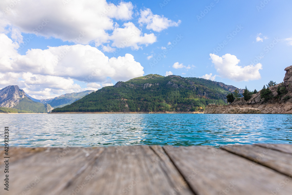 Panoramic view from wooden pier to mountains and azure lake. Beautiful summer landscape with selective focus. Taurus Canyon, Turkey