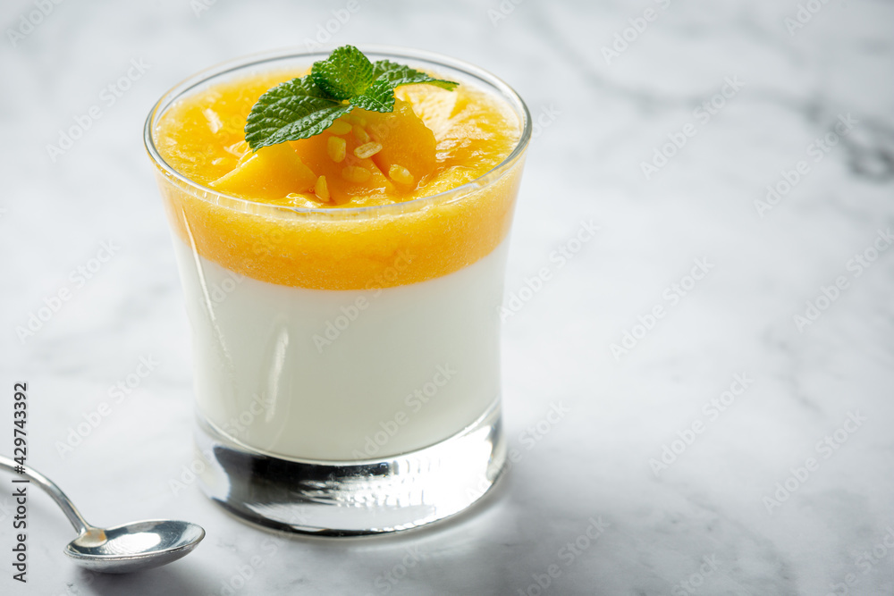 Homemade mango yoghurt on marble backgroud Homemade mango yoghurt on marble backgroud