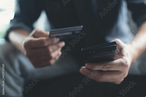 Man using credit card making internet payment for online shopping via mobile banking app on smartphone