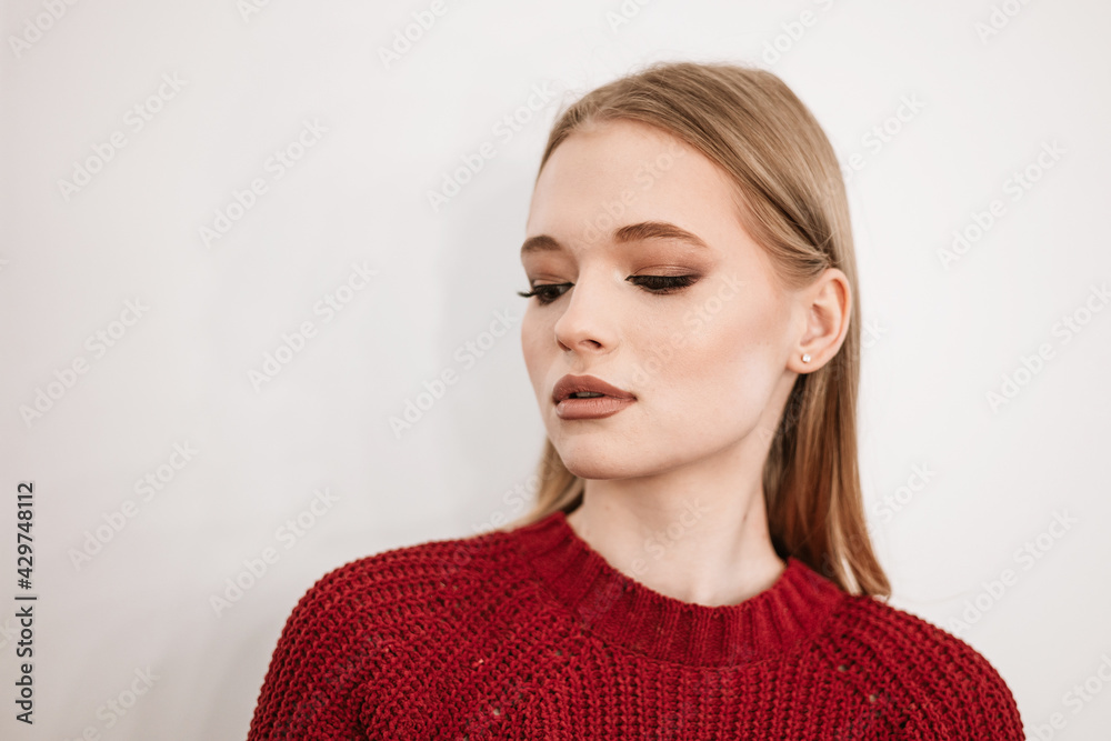 beautiful young blonde woman with a beautiful evening makeup stands in a beauty salon on white background beautiful young blonde woman with a beautiful evening makeup stands in a beauty salon on white background