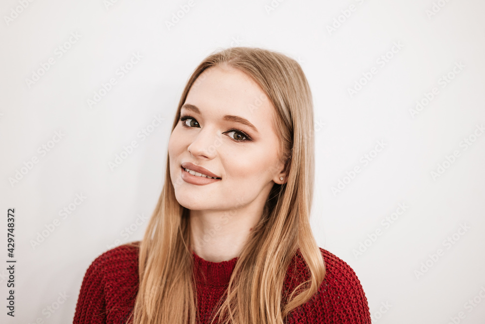 beautiful young blonde woman with a beautiful evening makeup stands in a beauty salon on white background beautiful young blonde woman with a beautiful evening makeup stands in a beauty salon on white background