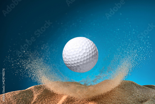golf ball flying through the sand