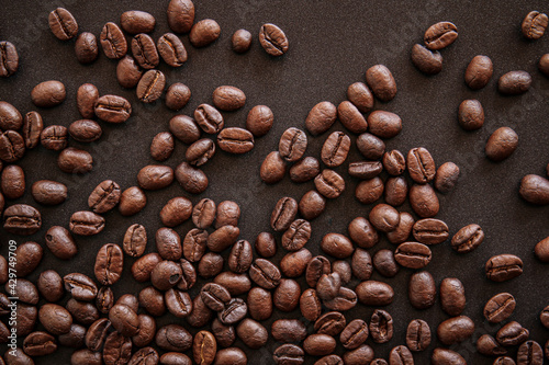 close up of roasted coffee beans on black background 