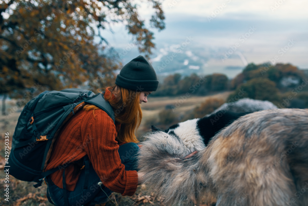 cheerful woman hiker hugging dog outdoors travel friendship