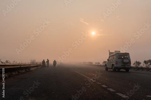 Indian Road Highways, Beautiful landscape of Indian roads during fog and sunrise in winter morning. Vehicles running on highways. © Abhishek Mittal