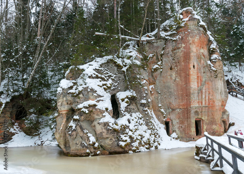 landscape with Anfabrikas rock Ligatne, artificial caves in the rock wall, all covered with snow, Ligatne, Latvia photo