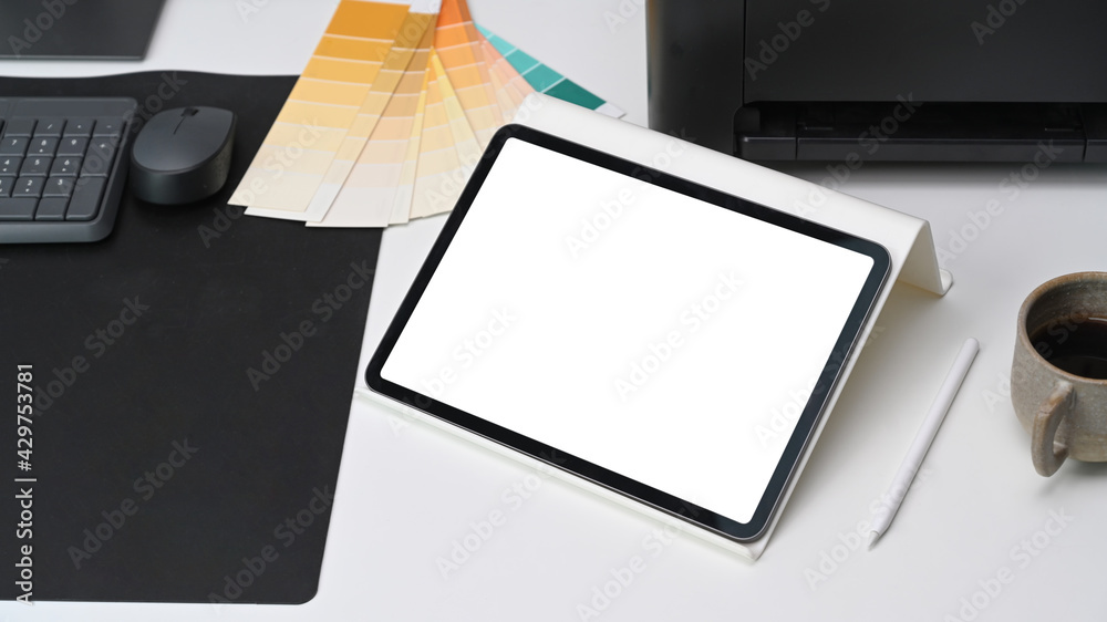 Close up view of digital tablet with white screen on graphic designer workspace. Close up view of digital tablet with white screen on graphic designer workspace.