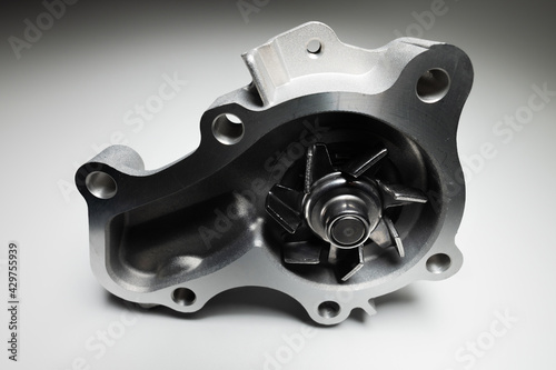 Water pump of the internal combustion engine cooling system. Contrasting on a gray gradient