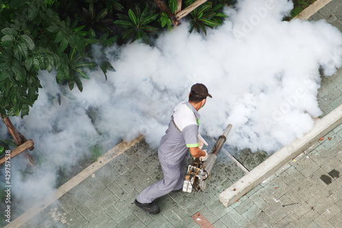 Service of spray insecticide smoke, Fogging machine spraying chemical to eliminate mosquitoes or pest in outdoor ornamental garden, Prevent dengue fever and zika virus in residential community.