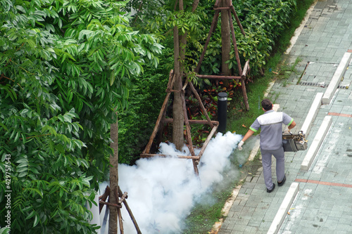 Top view of, Ornamental garden and service of spray insecticide smoke, Fogging machine spraying chemical to eliminate mosquitoes or pest, Prevent dengue fever and zika virus in residential community.