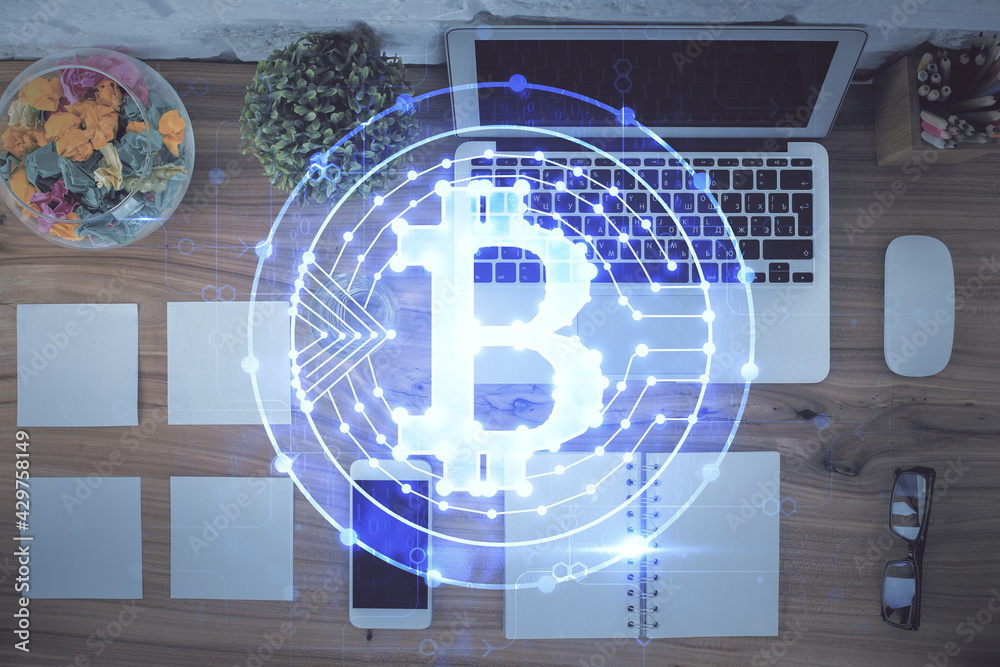 Blockchain theme hologram drawings over computer on the desktop background. Top view. Double exposure.