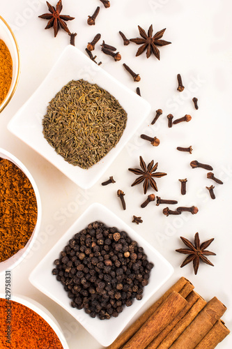 spices in ceramic bowls and white background stock photo