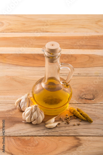 Garlic, turmeric with  essential oil in a bottle and wooden background stock photo