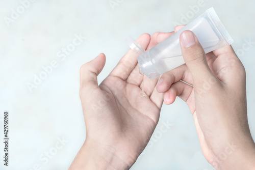 Man hand using alcohol wash gel for cleaning sanitizer gel pump dispenser on white background, health care concept for prevent covid-19