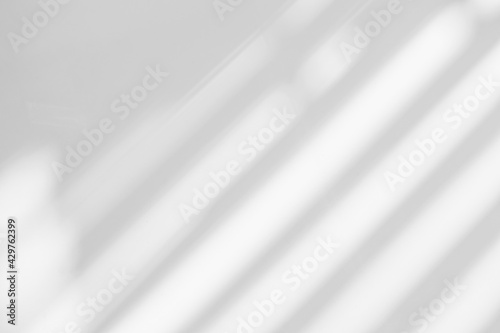 Abstract shadow and striped diagonal light blur background on white wall from window, architecture dark gray and sunshine diagonal geometric effect overlay