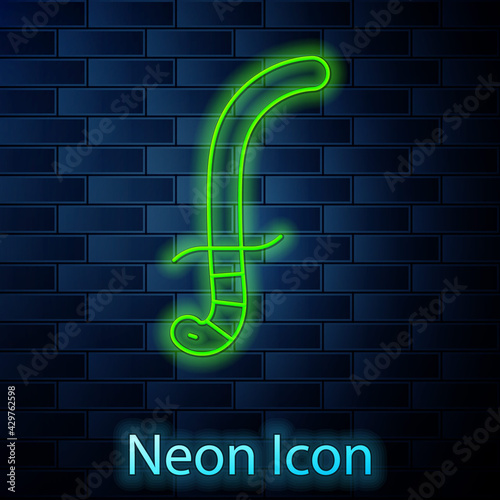Glowing neon line Medieval sword icon isolated on brick wall background. Medieval weapon. Vector