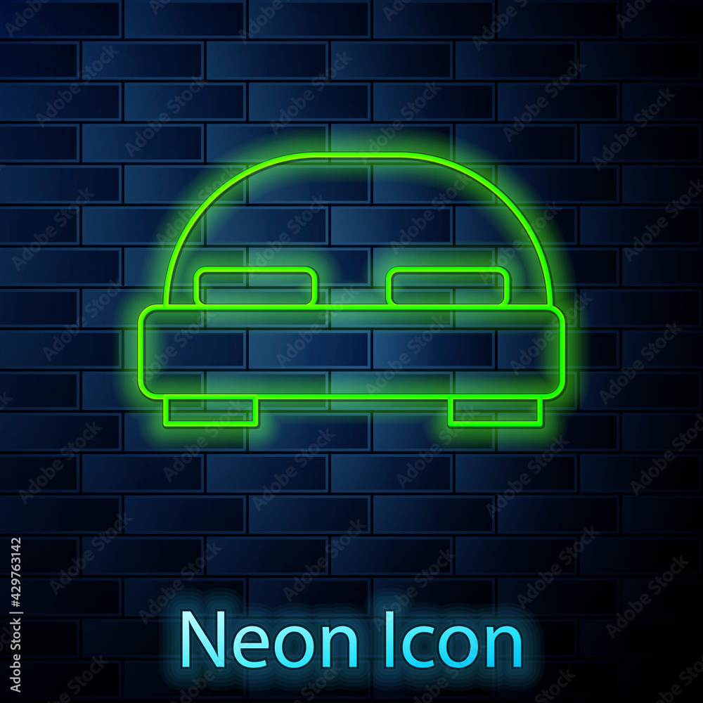 Glowing neon line Big bed for two or one person icon isolated on brick wall background. Vector