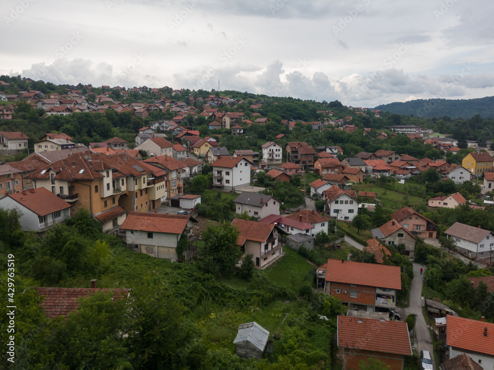 Aerial view of Doboj hilly suburbs from medieval fortress Gradina during overcast summer day.